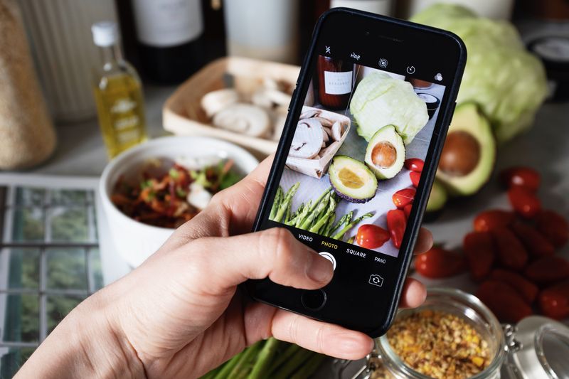 Eine gesunde Mahlzeit wird mit dem Smartphone fotografiert